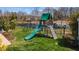 An outdoor playground with a slide and swingset next to a pond, perfect for Gathering fun and recreation at 1295 Kerr St, Burlington, NC 27215