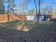 Large fenced backyard featuring an outbuilding/shed with mature trees at 1314 Hearthside St, Durham, NC 27707