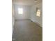 Bright bedroom with neutral carpeting, baseboard heating, and two windows for natural light at 1314 Hearthside St, Durham, NC 27707
