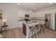 Modern kitchen featuring stainless steel appliances, an island with barstool seating, and granite countertops at 132 Rolesville Ridge Dr, Rolesville, NC 27571