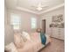 Bright bedroom featuring a tray ceiling, large windows, and stylish neutral decor at 132 Rolesville Ridge Dr, Rolesville, NC 27571