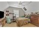 Bedroom featuring a large ceiling fan, various collectibles, a bed and a dresser at 1320 Rushing Creek Pkwy, Raleigh, NC 27610