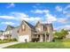 Charming two-story home features red shutters, attached garage, and a well-manicured lawn on a sunny day at 1320 Rushing Creek Pkwy, Raleigh, NC 27610