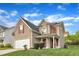 Charming two-story home features red shutters, attached garage, and a well-manicured lawn on a sunny day at 1320 Rushing Creek Pkwy, Raleigh, NC 27610