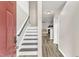 Inviting foyer with staircase, neutral paint, and wood-look flooring leading to a cozy living room with fireplace at 1320 Rushing Creek Pkwy, Raleigh, NC 27610