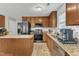 Well-equipped kitchen with granite countertops, stainless steel appliances, island, and ample cabinet space for storage at 1320 Rushing Creek Pkwy, Raleigh, NC 27610