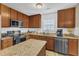 Well-equipped kitchen with granite countertops, stainless steel appliances, island, and ample cabinet space for storage at 1320 Rushing Creek Pkwy, Raleigh, NC 27610