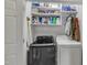 Laundry room featuring a modern washer and dryer set with storage shelving and ample space for laundry tasks at 1320 Rushing Creek Pkwy, Raleigh, NC 27610
