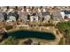 Aerial view of pond and suburban neighborhood, showcasing the home's proximity to the water at 1624 Pantego Trl, Cary, NC 27519