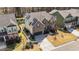 Aerial view of a two-story home with solar panels, manicured landscaping, and a nearby pond at 1624 Pantego Trl, Cary, NC 27519