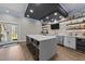 A contemporary entertainment bar with stone accents, custom shelving and a wine fridge at 1624 Pantego Trl, Cary, NC 27519