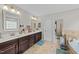 Elegant bathroom featuring double vanities and a separate shower, creating a luxurious experience at 1624 Pantego Trl, Cary, NC 27519