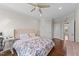 Comfortable bedroom with a large bed, hardwood floors, and neutral color palette at 1624 Pantego Trl, Cary, NC 27519