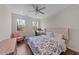 Bright bedroom with a ceiling fan, natural light, and a dedicated workspace at 1624 Pantego Trl, Cary, NC 27519