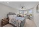 Bright bedroom featuring multiple windows, neutral carpet flooring, and a ceiling fan at 1624 Pantego Trl, Cary, NC 27519