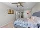 Comfortable bedroom with a ceiling fan, carpet flooring, and an attached room at 1624 Pantego Trl, Cary, NC 27519