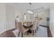 Bright dining room with hardwood floors, modern chandelier, and inviting atmosphere at 1624 Pantego Trl, Cary, NC 27519
