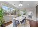 Bright dining area with hardwood floors, large windows, and a table that seats six at 1624 Pantego Trl, Cary, NC 27519