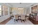 Stylish dining room with modern chandelier, decorative wall art, and ample seating at 1624 Pantego Trl, Cary, NC 27519