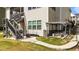 Side view of a patio with a garden and stairs to a screened-in porch on the second story at 1624 Pantego Trl, Cary, NC 27519