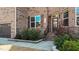 Close up of front entrance to a beautiful brick two-story home with manicured landscaping at 1624 Pantego Trl, Cary, NC 27519