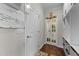 Hallway with hardwood floors, and a closet with decorative glass paned doors for a light, bright look at 1624 Pantego Trl, Cary, NC 27519