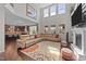 Bright living room with a fireplace, large windows, high ceilings, and an open concept layout to the kitchen at 1624 Pantego Trl, Cary, NC 27519