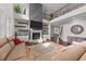 Bright open living room, featuring a fireplace and built-in shelves, seamlessly connecting to the upper level at 1624 Pantego Trl, Cary, NC 27519