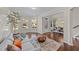 Inviting living room featuring large windows, hardwood floors, and stylish decor at 1624 Pantego Trl, Cary, NC 27519