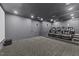 Finished theater room featuring tiered seating, projector screen, and integrated speakers at 1624 Pantego Trl, Cary, NC 27519