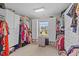 Spacious walk-in closet with built-in shelving and a window, offering ample storage at 1624 Pantego Trl, Cary, NC 27519