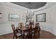 Well-lit dining room features wood floors, a modern chandelier, and neutral wall colors at 1824 Longmont Dr, Wake Forest, NC 27587
