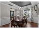 Formal dining room with a large chandelier, hardwood floors, and elegant finishes at 1824 Longmont Dr, Wake Forest, NC 27587