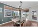 Dining room with wood table, large windows, ample natural light, and wood floors at 1824 Longmont Dr, Wake Forest, NC 27587