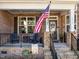 Cozy front porch with stone accents, seating, and a welcoming American flag at 1824 Longmont Dr, Wake Forest, NC 27587