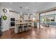Open concept kitchen with granite counters, stainless appliances, island with seating, and hardwood floors at 1824 Longmont Dr, Wake Forest, NC 27587