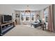 Bright living room featuring large windows, comfortable seating, and stylish decor at 1824 Longmont Dr, Wake Forest, NC 27587