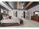 Spacious main bedroom with tray ceiling, wood beams, sitting area, and luxurious accents at 1824 Longmont Dr, Wake Forest, NC 27587