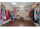 Spacious walk-in closet with wood floor, shelving, clothes racks, and natural light from a window at 1824 Longmont Dr, Wake Forest, NC 27587