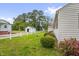 Spacious backyard with well-maintained lawn, white fence, lush greenery and a storage shed at 200 N 9Th St, Erwin, NC 28339