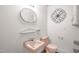 Quaint bathroom with pastel pink fixtures, including a sink and toilet, offering vintage charm and functionality at 200 N 9Th St, Erwin, NC 28339