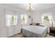 Comfortable bedroom featuring neutral tones, ample natural light from multiple windows, and simple furnishings at 200 N 9Th St, Erwin, NC 28339