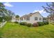 Exterior view of a charming home featuring a well-manicured lawn, colorful bushes, and a cozy curb appeal at 200 N 9Th St, Erwin, NC 28339