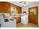 Well-lit kitchen with wood cabinets, appliances, and a view of the exterior through the window above the sink at 200 N 9Th St, Erwin, NC 28339