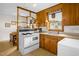 Functional kitchen space featuring classic appliances, wood cabinets, and eat-in kitchen at 200 N 9Th St, Erwin, NC 28339