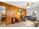 Cozy living room with wood-paneled wall and neutral carpet, furnished with traditional sofa and side tables at 200 N 9Th St, Erwin, NC 28339