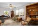 Bright living room featuring a ceiling fan, large windows with natural light, and comfortable seating at 200 N 9Th St, Erwin, NC 28339