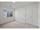 Carpeted bedroom featuring two doors and a window for natural light at 2011 Wolftech Ln # 203, Raleigh, NC 27603