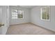 Comfortable bedroom featuring neutral carpet, windows, and closet space at 2011 Wolftech Ln # 203, Raleigh, NC 27603