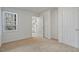 Neutral bedroom with carpet flooring, a window, and white doors at 2011 Wolftech Ln # 203, Raleigh, NC 27603